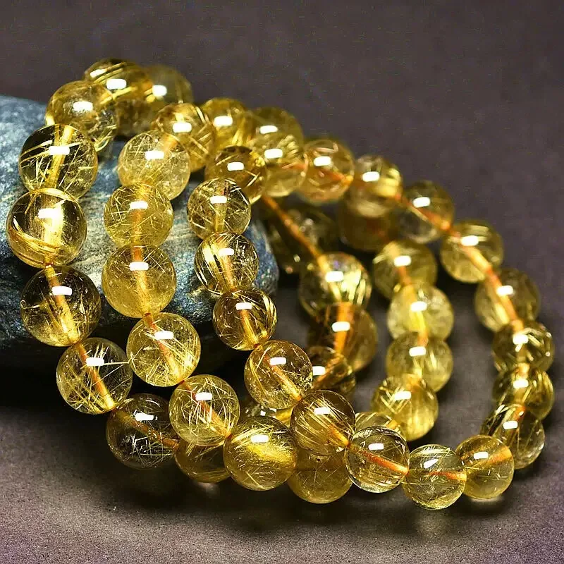 Wholesale Gold Rutilated Quartz Bracelets — Clear quartz threaded with natural golden rutile needles — a premium seller.