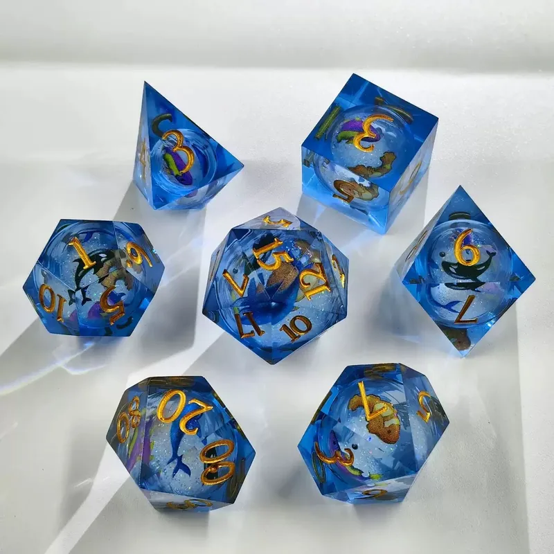 Wholesale Ocean Blue Resin Dice — Blue sharp-edge resin with sea-creature inclusions and glitter, gold ink.